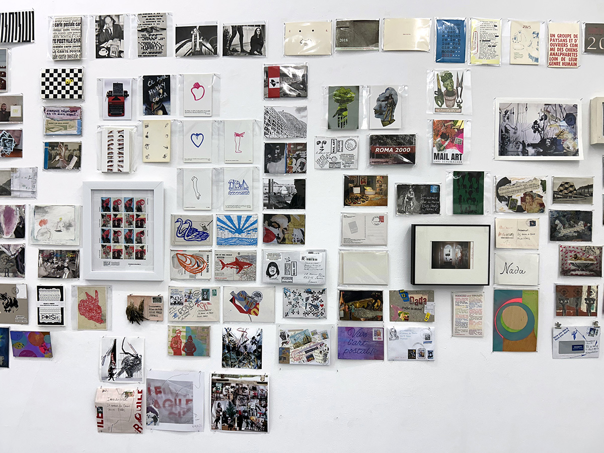 The postcard editions Entre!, Point of View, Roma 2000 and Nada among many others on the wall at Immanence